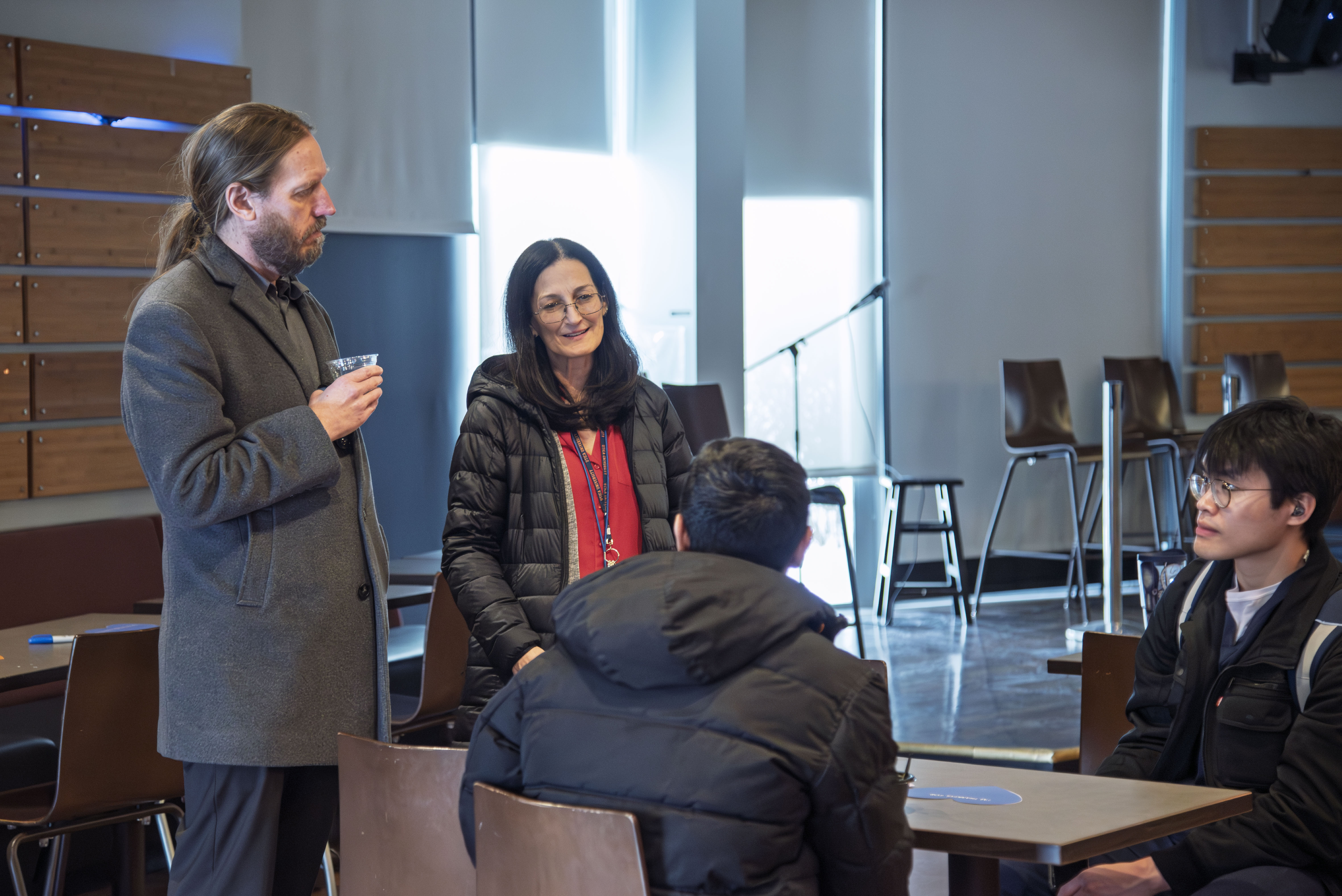 Deans Jason Denman and Sharon Wise chat with studetns in the Pioneer Pub.