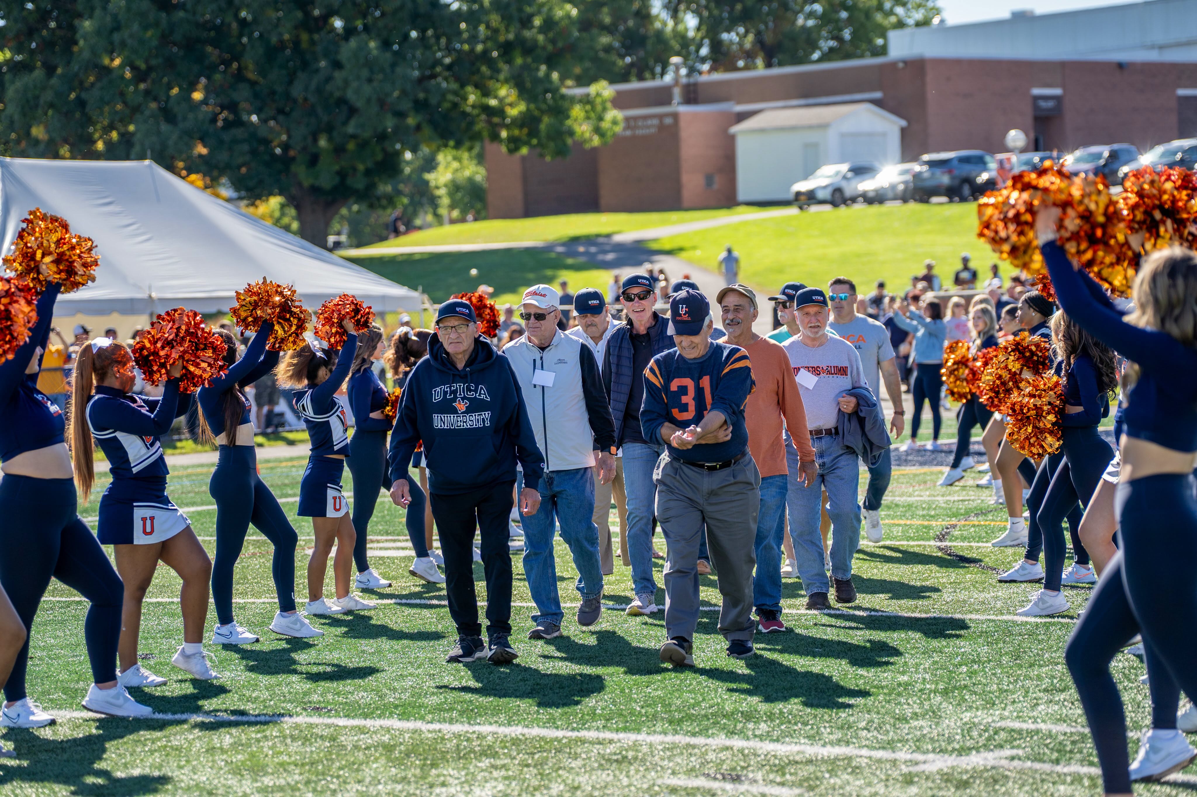 Members of the 1970 Football Team walk the field at the 2026 Homecoming game.
