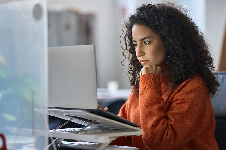 Woman researching options on her laptop