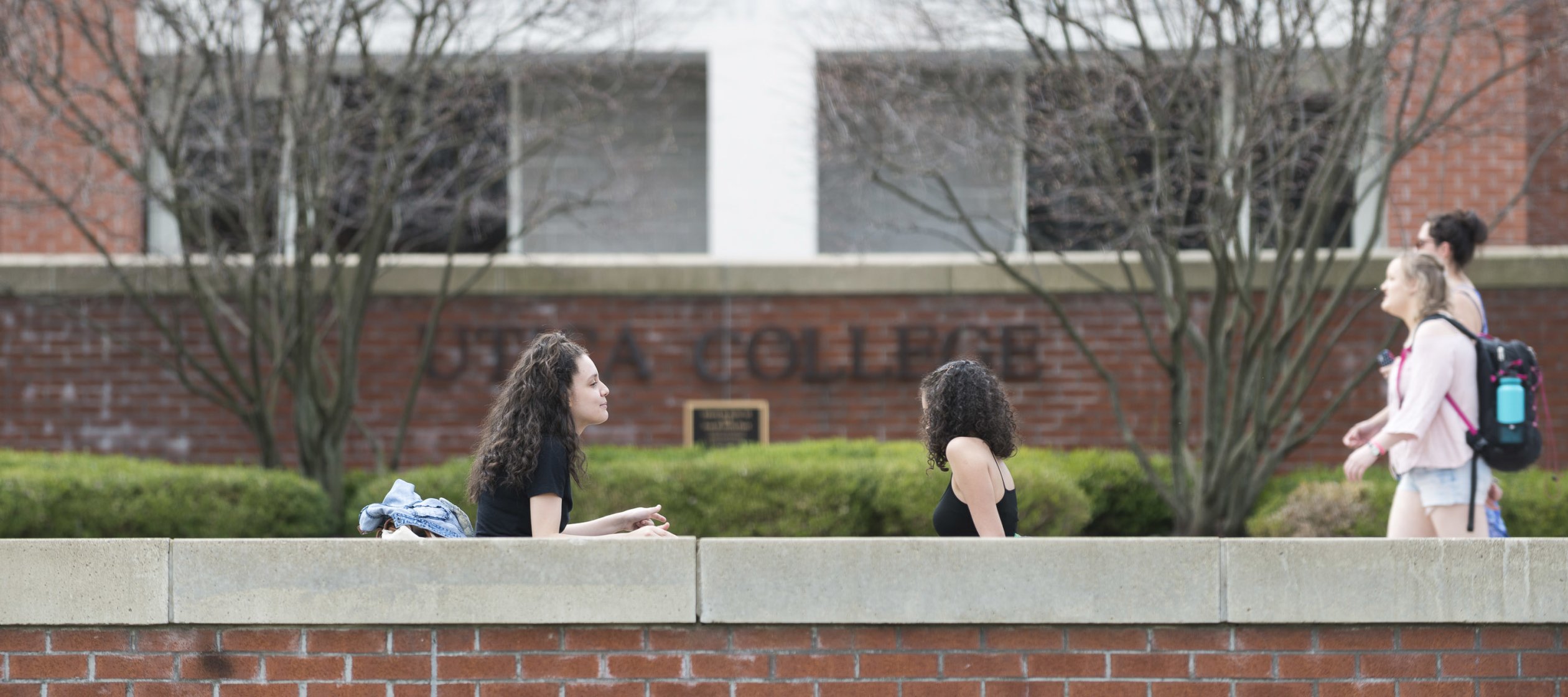 Campus Scenic - Spring - Women Sitting in front of Boehlert Hall