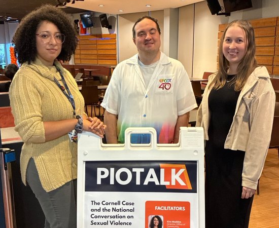 Kira Maddox, Kyle Wilson, and Alicia Reed stand by a sign for PioTalk.