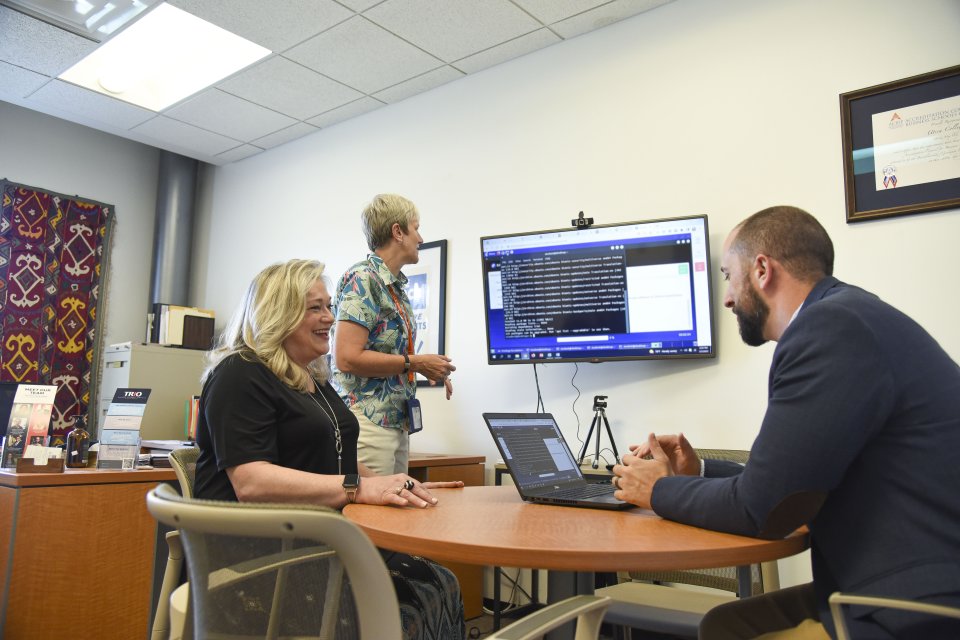 Leslie Corbo and Andrew Carr, along with Stephanie Nesbitt, Dean of Business and Justice and Associate Professor of Risk Management and Insurance, brainstorm ways to improve coursework for students.