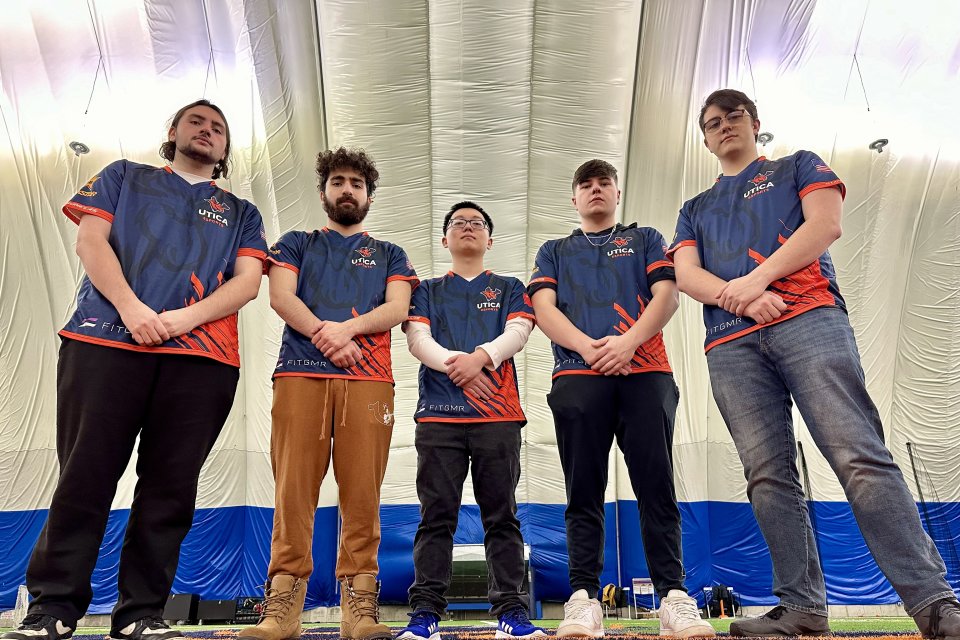 Members of the 2023 Esports Finals Team stands with arms resting in front.