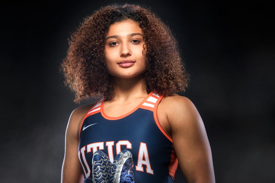 Jazmene Molina in a Utica Pioneers jersey, stands against a black background.